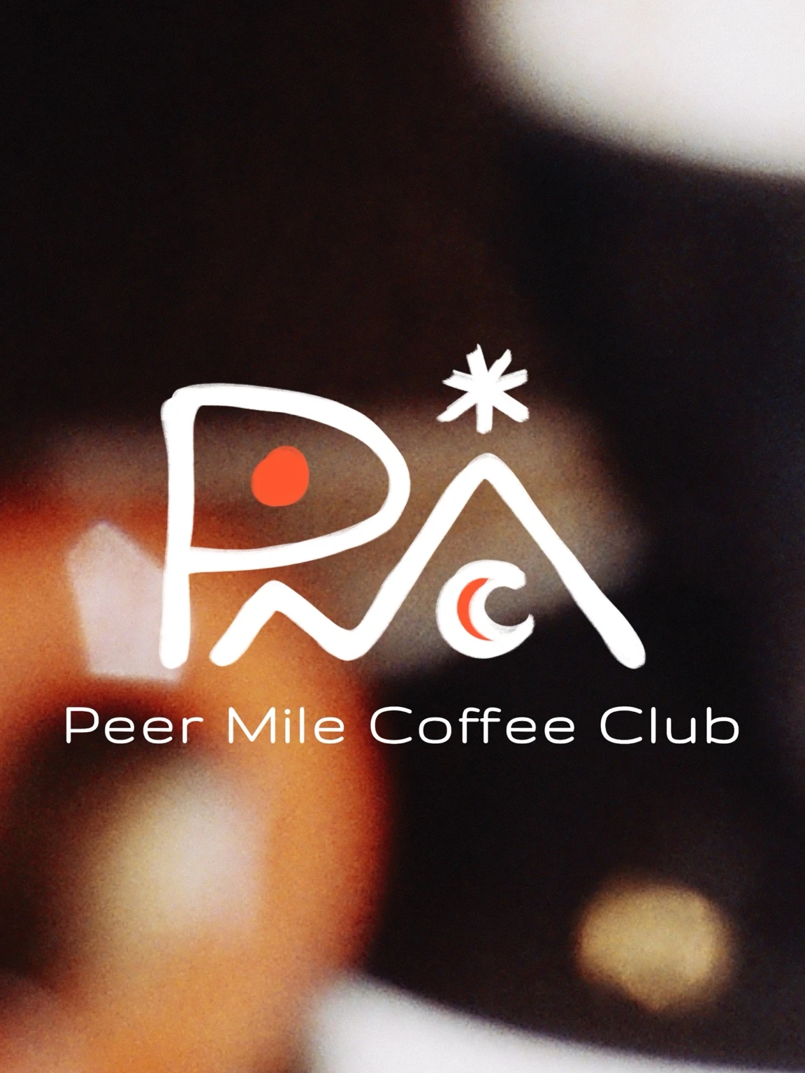The original Peer Mile Coffee Club logo: expressive white strokes with orange accents over a warm, softly focused photograph.